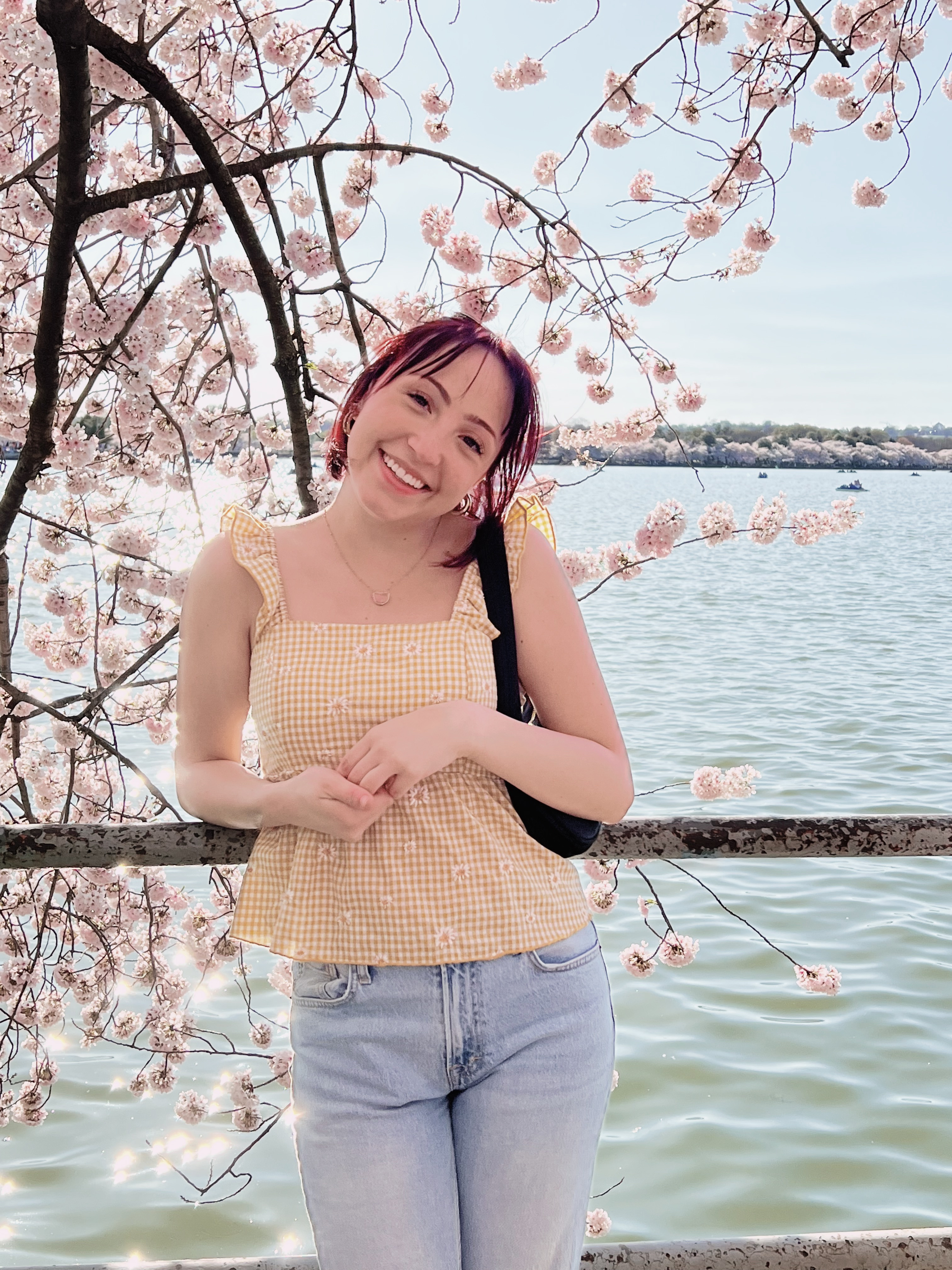 Caroline Pecora smiling under cherry blossoms